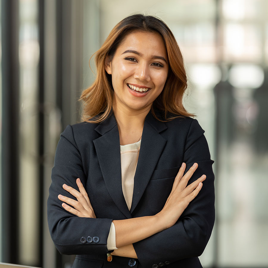 smiling-pretty-business-asian-woman-with-arms-cros-EJK7XZY.jpg